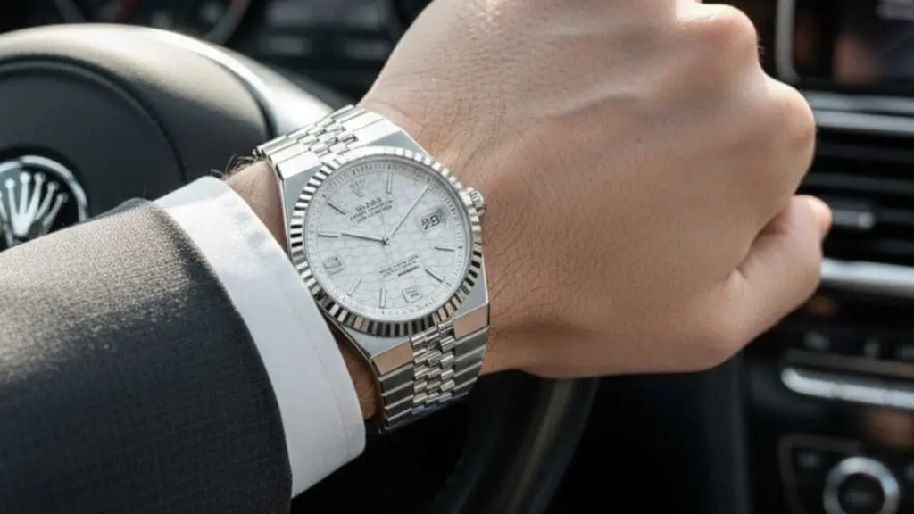 Man in Car Wearing Rolex Land-Dweller