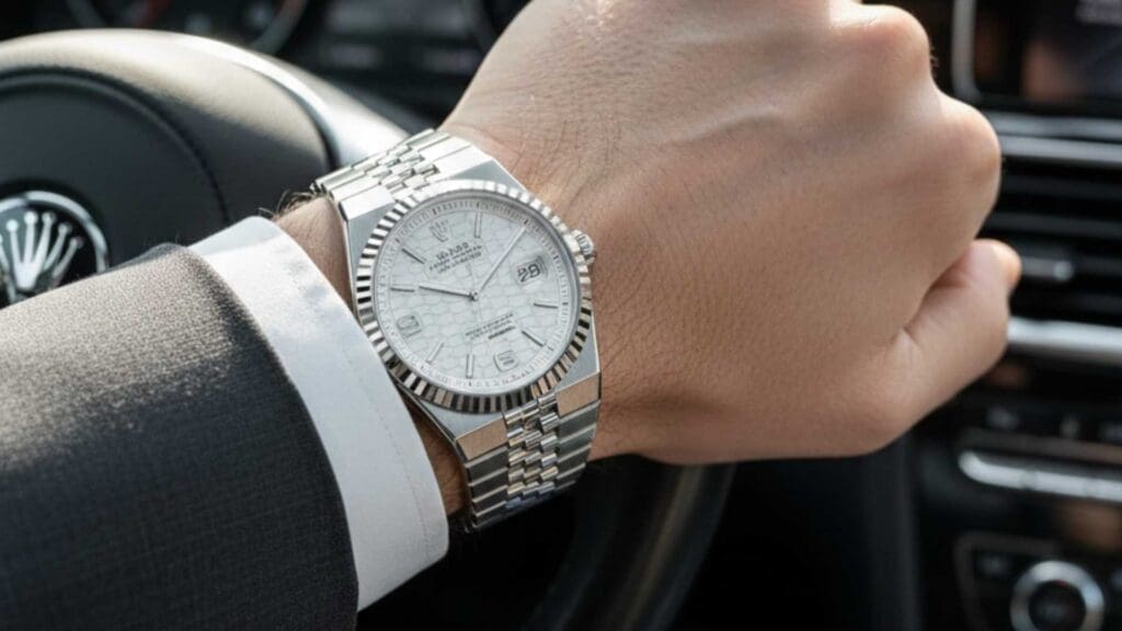 Man in Car Wearing Rolex Land-Dweller