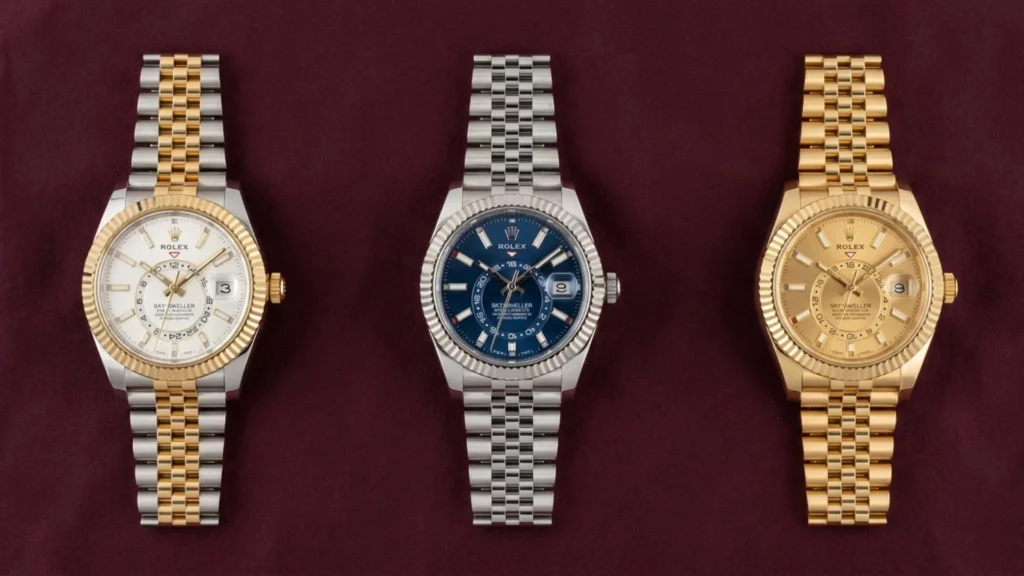 Rolex Sky-Dweller in two-tone white dial, steel blue dial, and yellow gold champagne dial on jubilee bracelets on dark red velvet