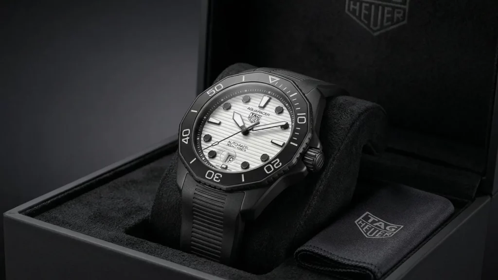 TAG Heuer Aquaracer white dial on black rubber strap inside open black TAG Heuer box