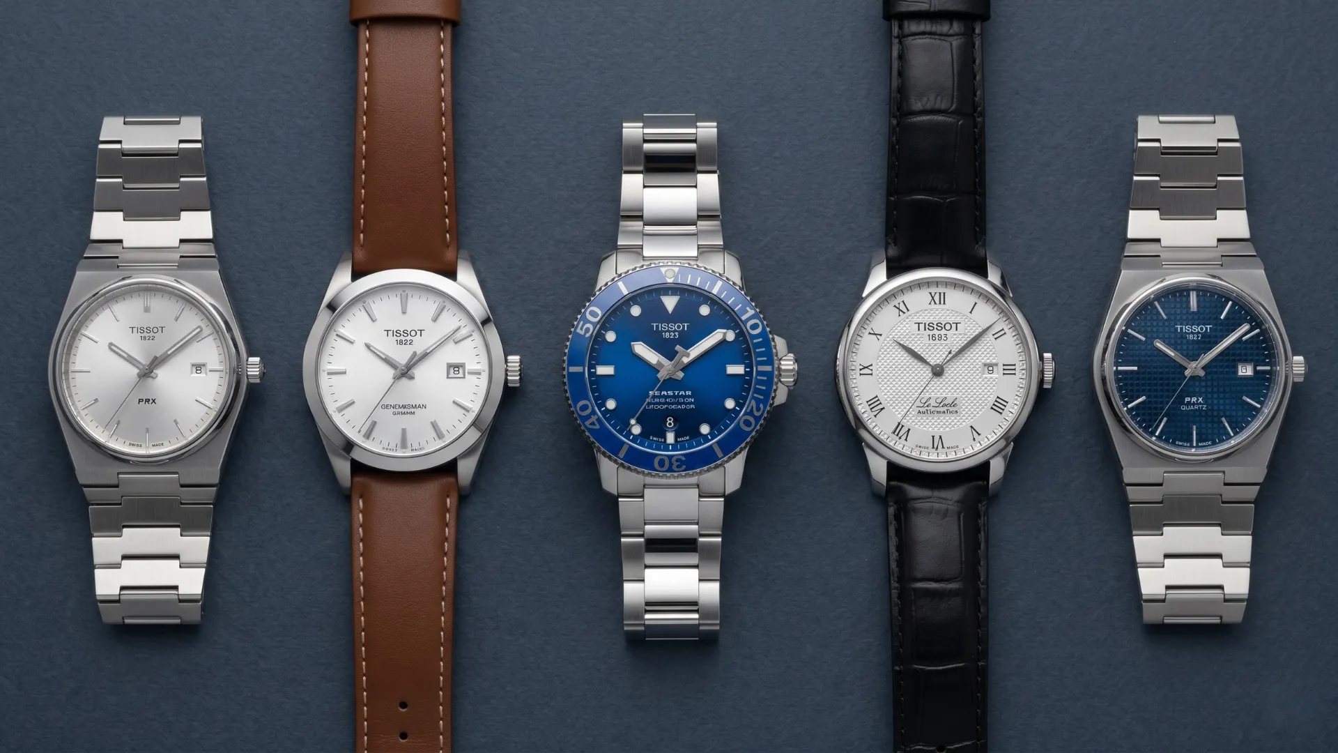 Five Tissot models laid out on blue surface including PRX steel bracelet, Gentleman brown leather, Seastar blue diver, Le Locle black leather, and PRX blue bracelet