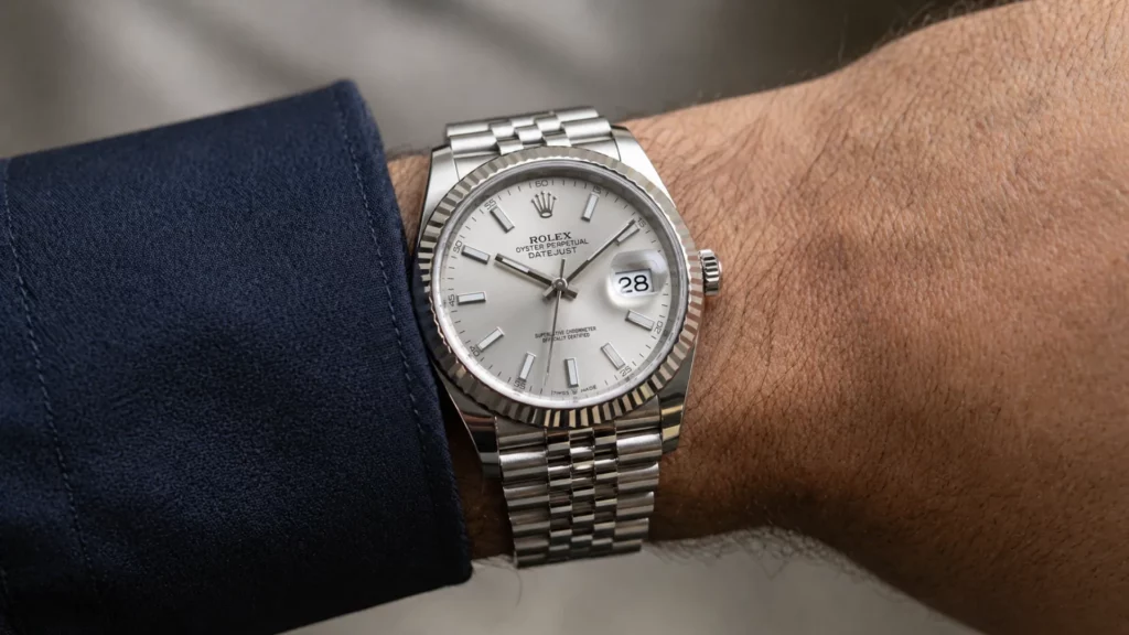 Rolex Datejust 36 with silver dial and fluted bezel on Jubilee bracelet on wrist with navy cuff