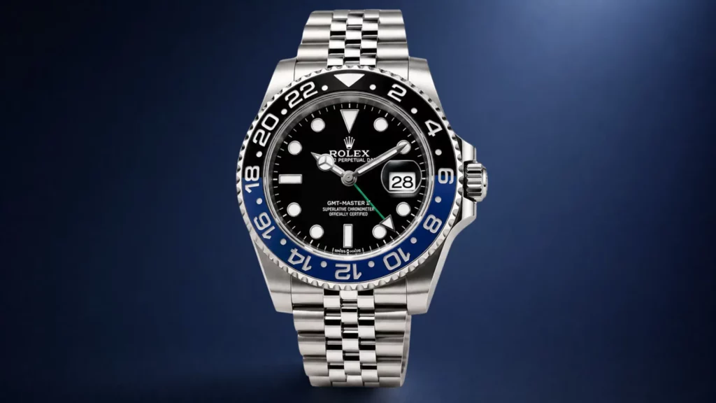 Rolex GMT-Master II Batman 126710BLNR with black and blue ceramic bezel on Jubilee bracelet against blue background