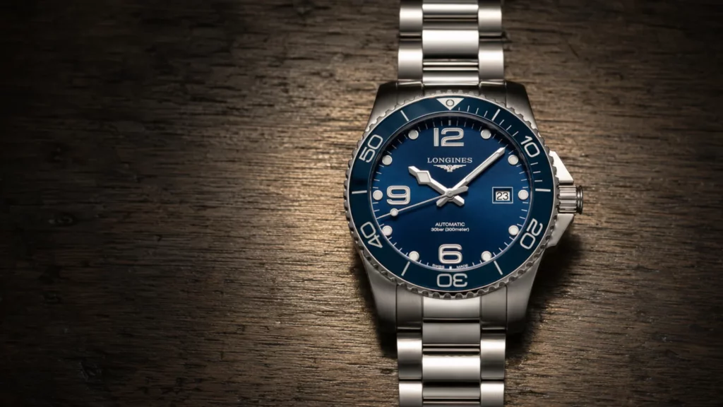 Longines HydroConquest previous generation blue dial watch on steel bracelet over dark wood