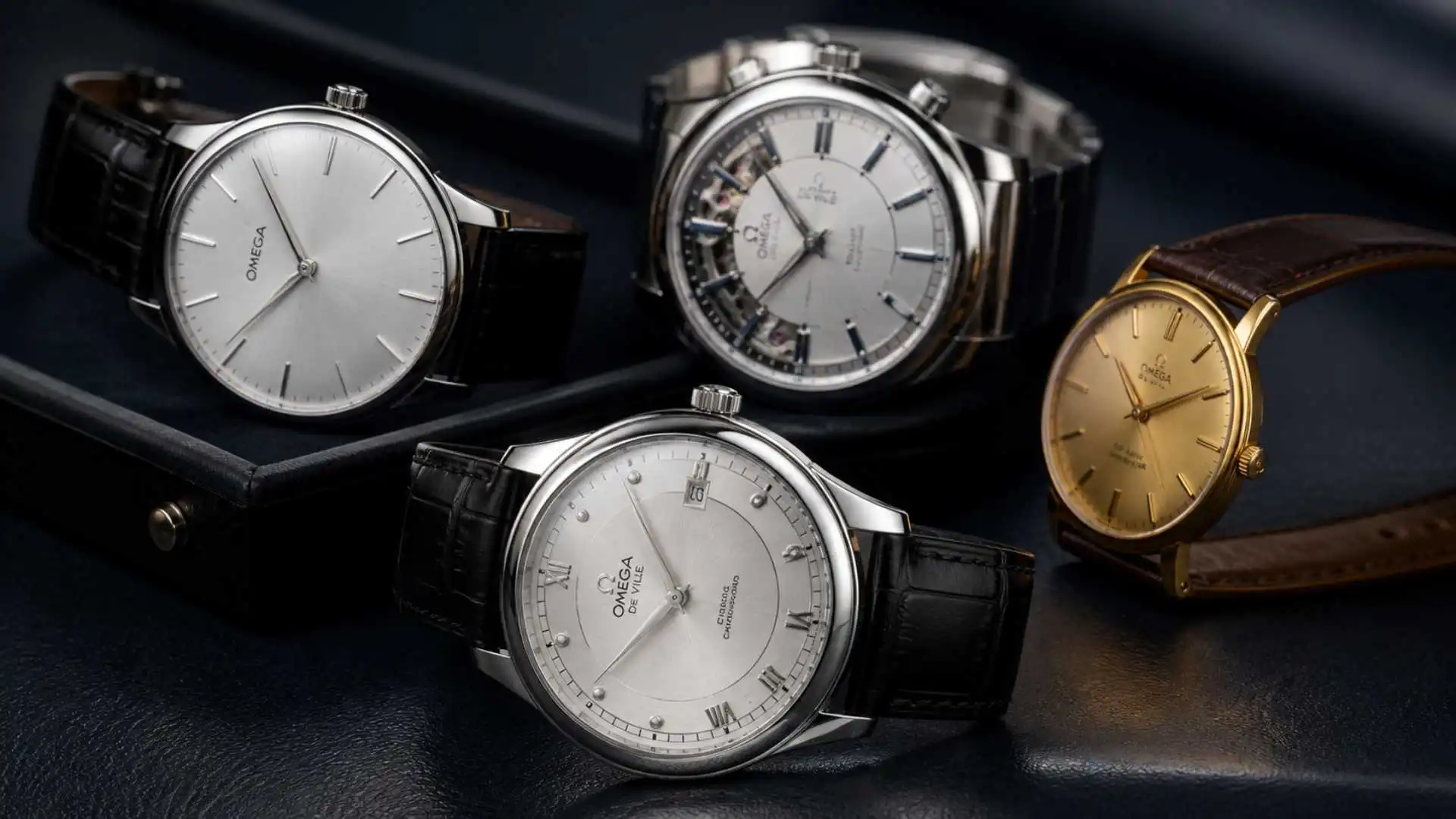 Omega De Ville watches displayed on a luxury reflective surface