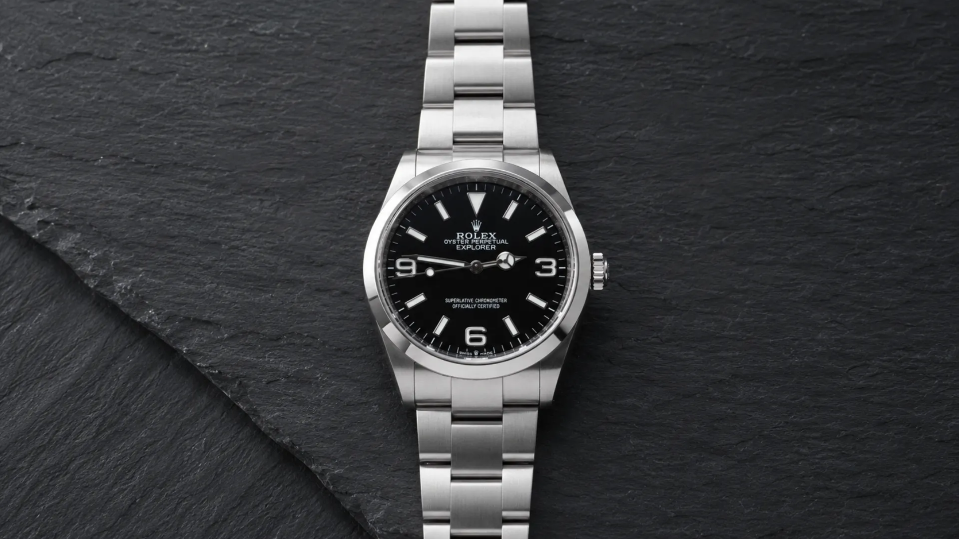 Rolex Explorer with black dial displayed on dark slate background