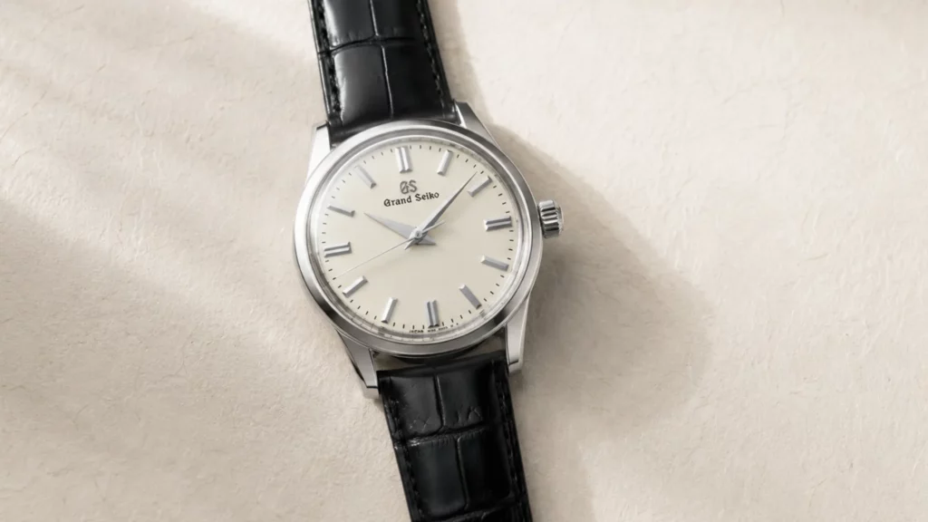 Grand Seiko SBGW231 with ivory dial and black leather strap on cream textured background