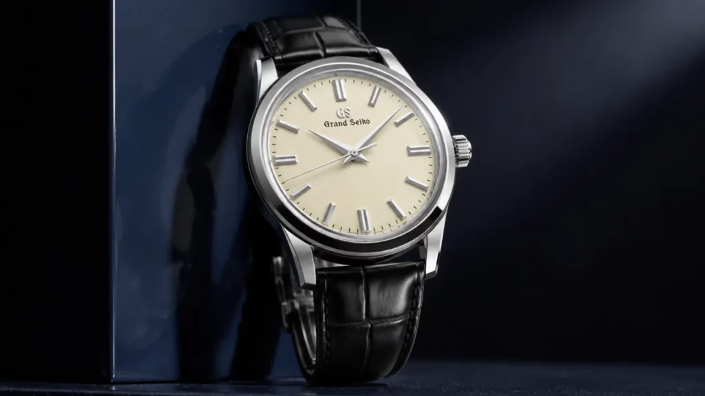 Grand Seiko SBGW301 with cream dial and black leather strap on dark blue background