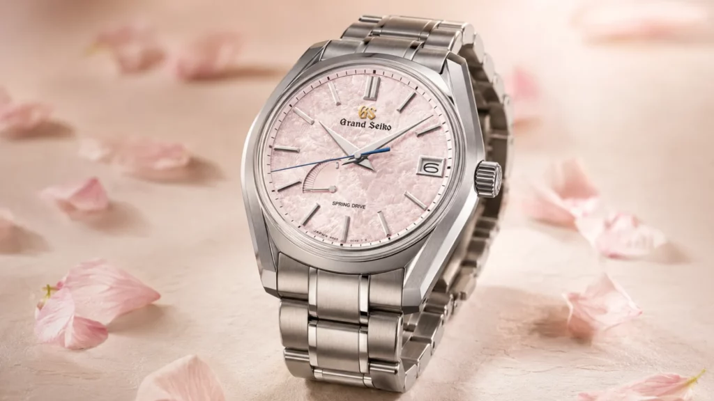 Grand Seiko Shunbun SBGA413 with cherry blossom pink dial and titanium bracelet surrounded by sakura petals