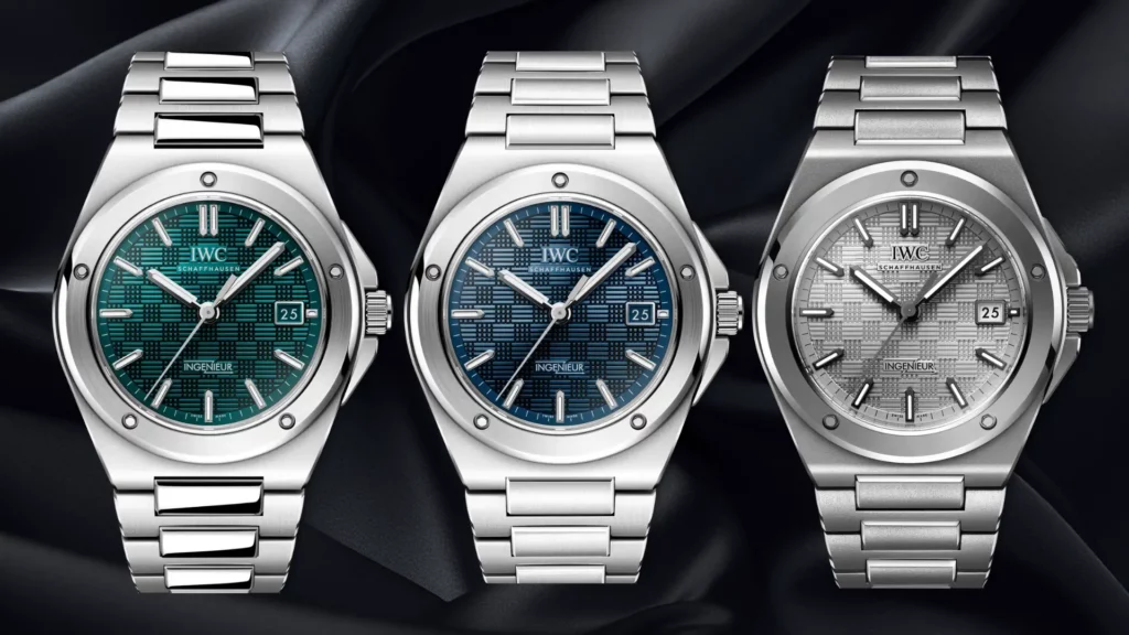 Three IWC Ingenieur references with green, blue, and silver grid-textured dials on black silk