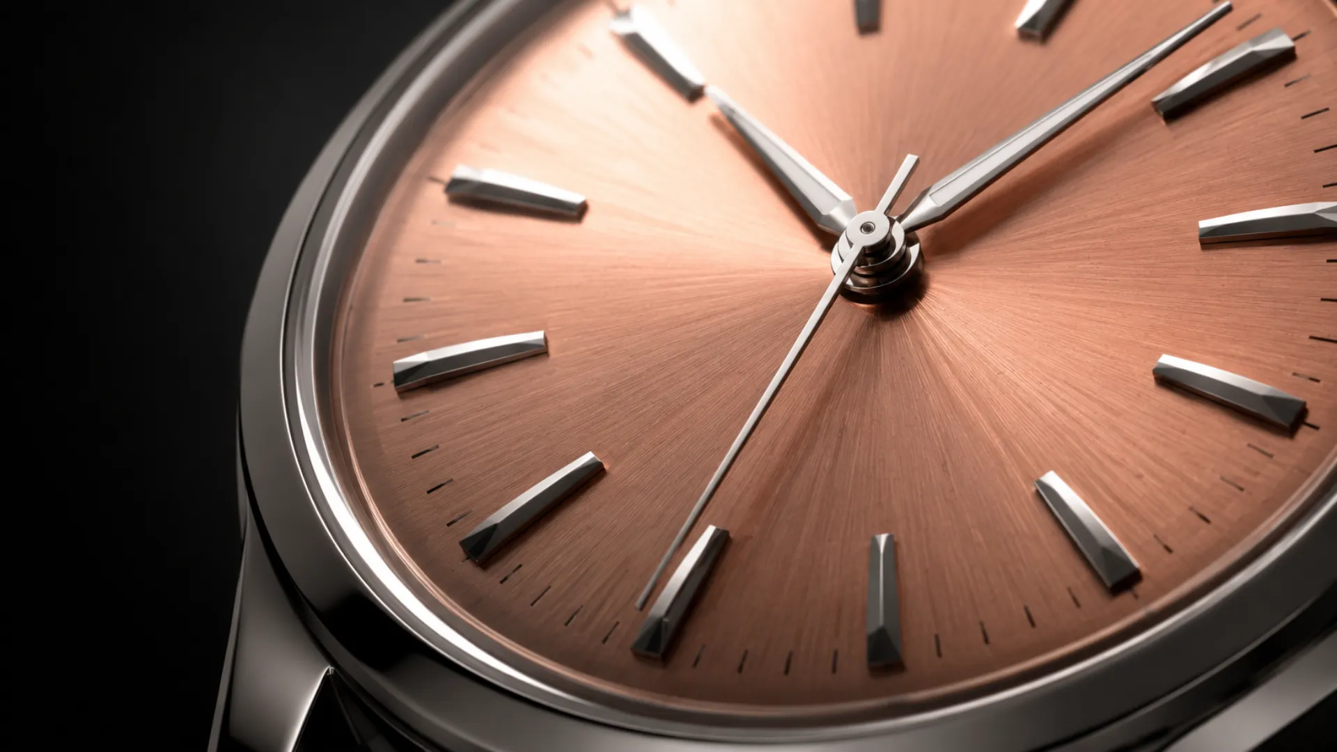 Close-up of a salmon dial watch showing the pinkish-copper metallic glow collectors chase