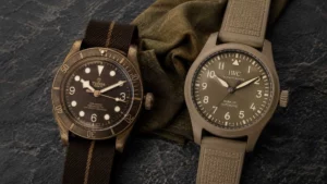 A bronze watch and a sand ceramic pilot watch side by side on a slate surface — best tan watches