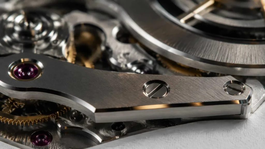 Close-up of luxury skeleton watch movement showing hand-finished beveled bridges and polished rotor