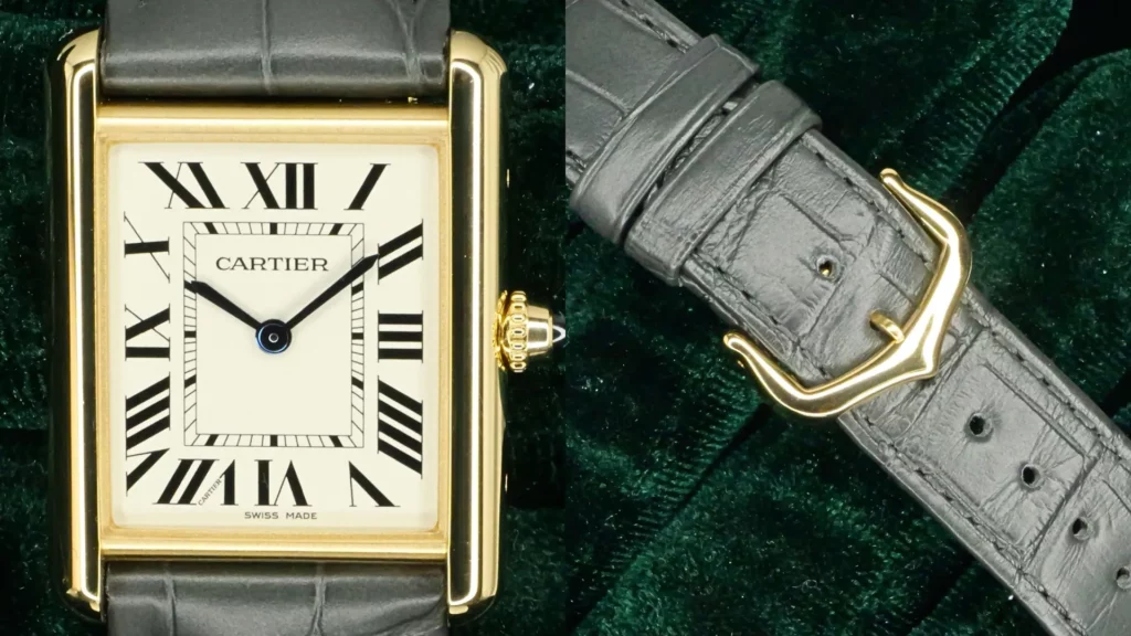 Yellow gold Cartier Tank Louis Cartier with cream Roman numeral dial on grey strap, alongside its gold pin buckle, on green velvet