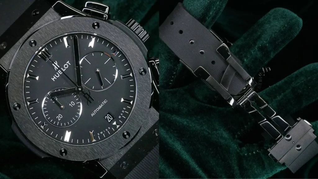 Hublot Classic Fusion chronograph in black ceramic with black dial beside close-up of its black rubber strap on dark green velvet