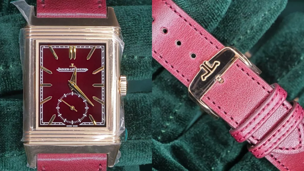 Rose gold Jaeger-LeCoultre Reverso with burgundy dial and small seconds on a red leather strap, alongside its signed buckle, on green velvet