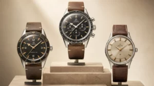 Three vintage Omega watches, a Seamaster 300, Speedmaster, and Constellation, on stone display stands