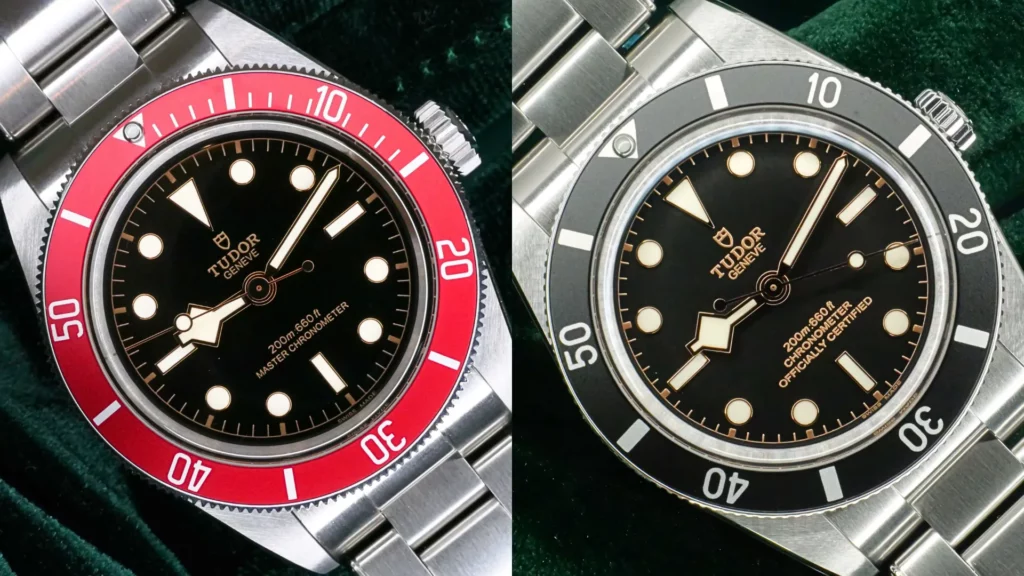 Side-by-side comparison of two Tudor Black Bay no-date watches, featuring red and black dive bezels, black dials, gilt accents and stainless steel bracelets.