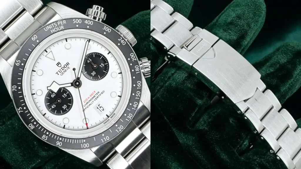 Tudor Black Bay Chrono with white dial and black subdials beside close-up of its steel bracelet clasp on dark green velvet