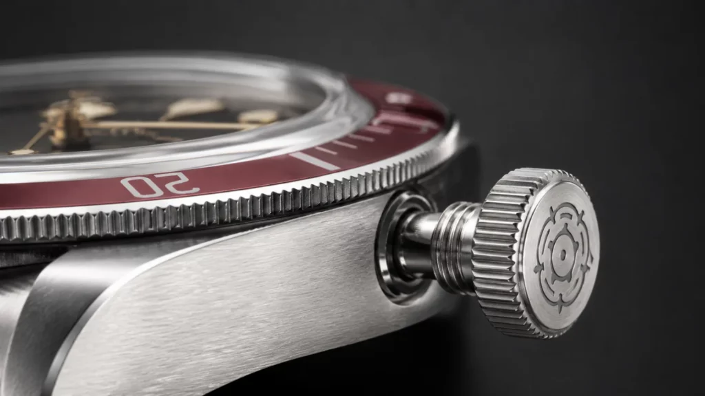 Unscrewing the screw-down crown on a Tudor Black Bay before setting the time