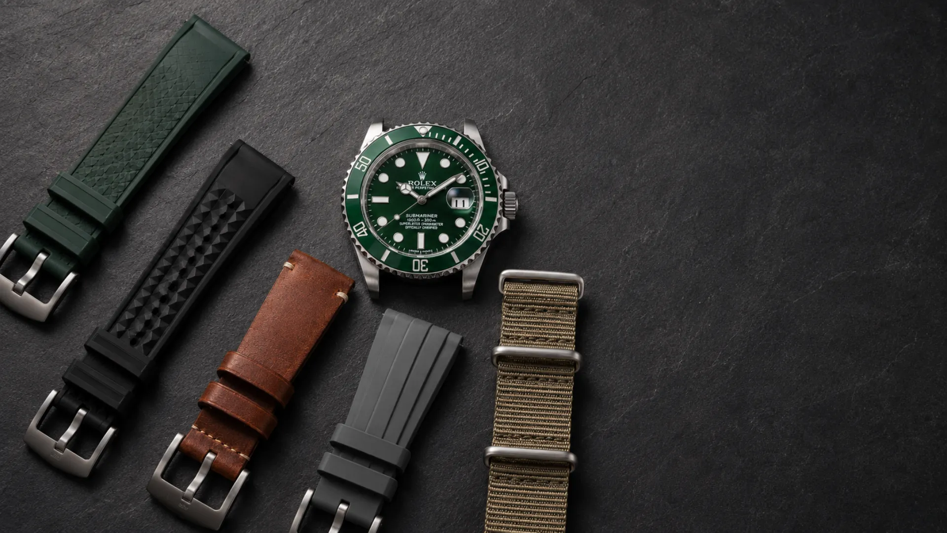 Green dial and black-and-green bezel dive watch surrounded by strap colors that suit it