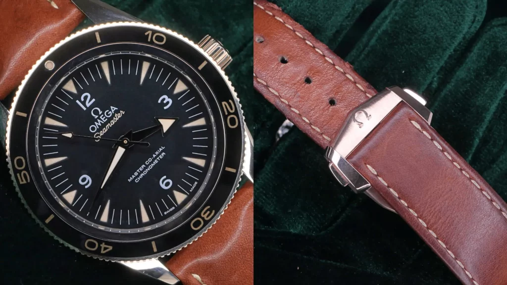 Omega Seamaster 300 in Sedna gold with black dial and brown leather strap with signed buckle on green velvet