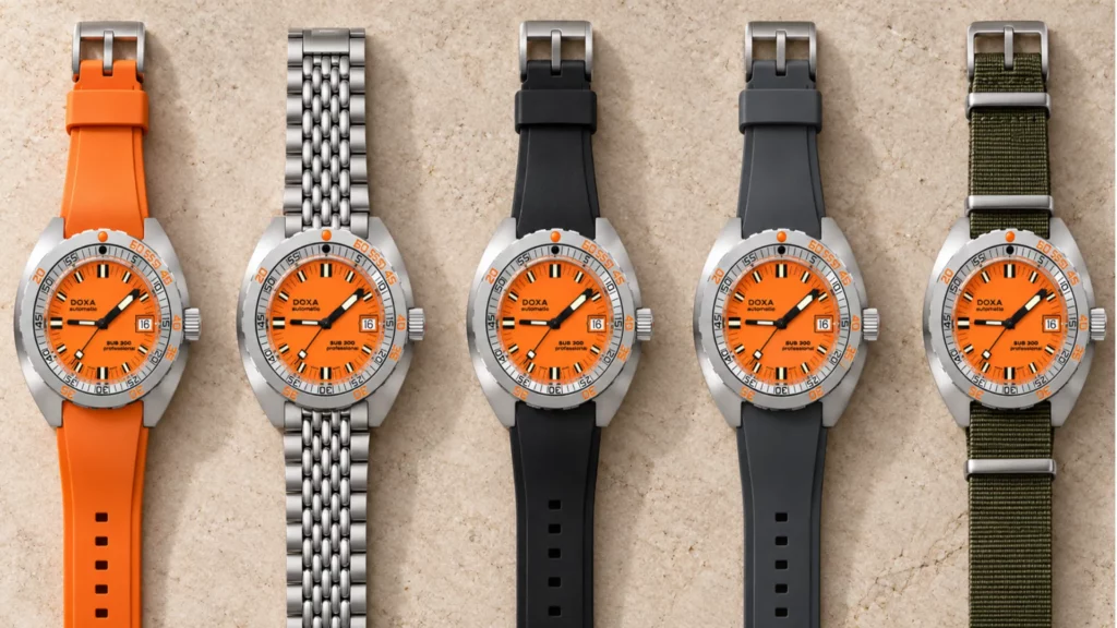 Doxa Sub 300 orange dial shown on orange rubber, beads-of-rice bracelet, black, charcoal, and olive straps