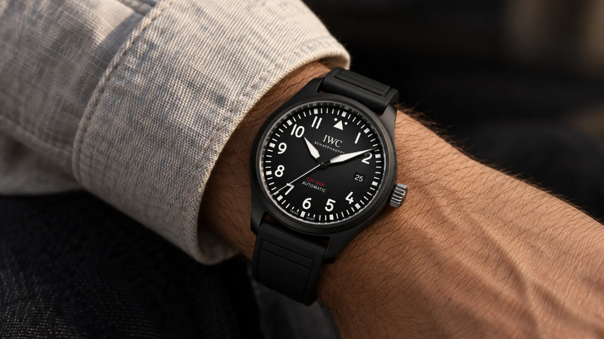 Full black watch styled on the wrist with a light layer for contrast