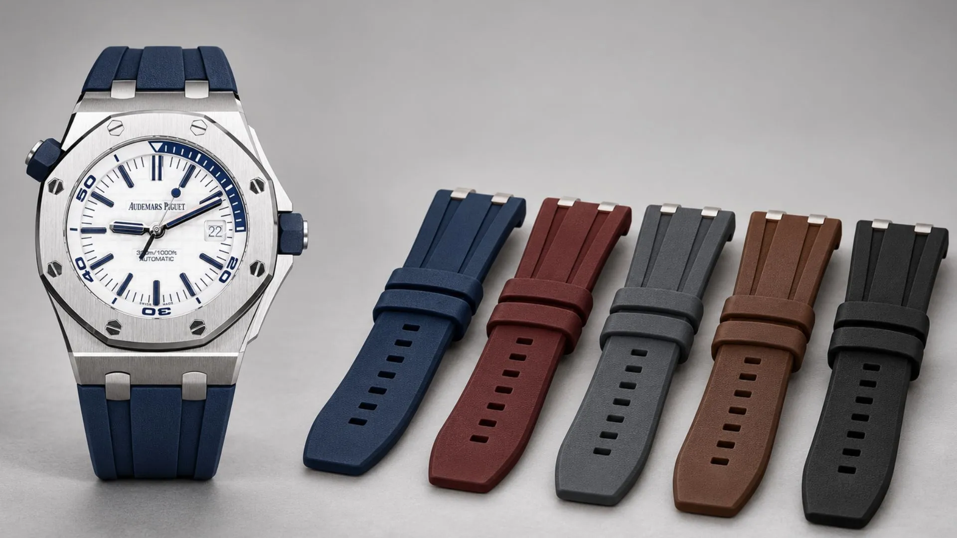 Steel Audemars Piguet Royal Oak Offshore Diver with white dial beside blue, burgundy, grey, brown, and black rubber straps