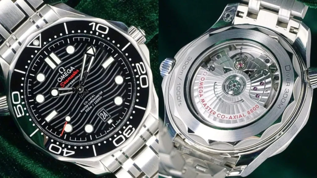 Steel Omega Seamaster Diver 300M with black wave dial and exhibition caseback showing the Co-Axial 8800 movement on green velvet