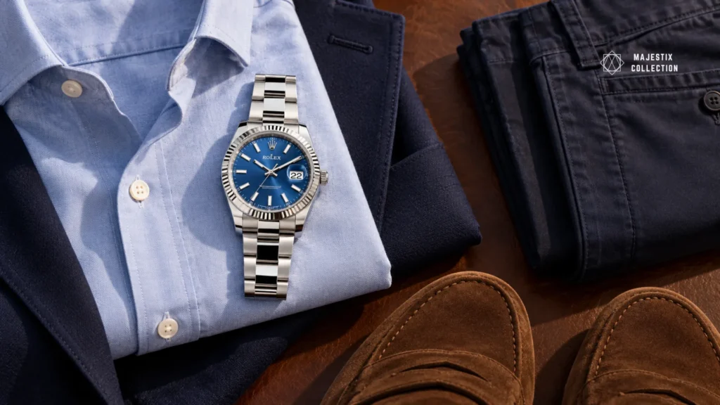 Blue Oxford shirt, navy blazer, and suede loafers outfit with a blue dial Rolex Datejust 41 on an Oyster bracelet