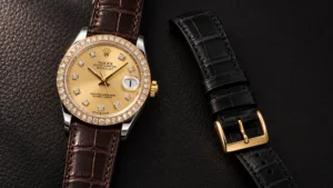 Strap colors that suit a diamond bezel: two-tone gold watch on a dark brown alligator strap beside a black strap