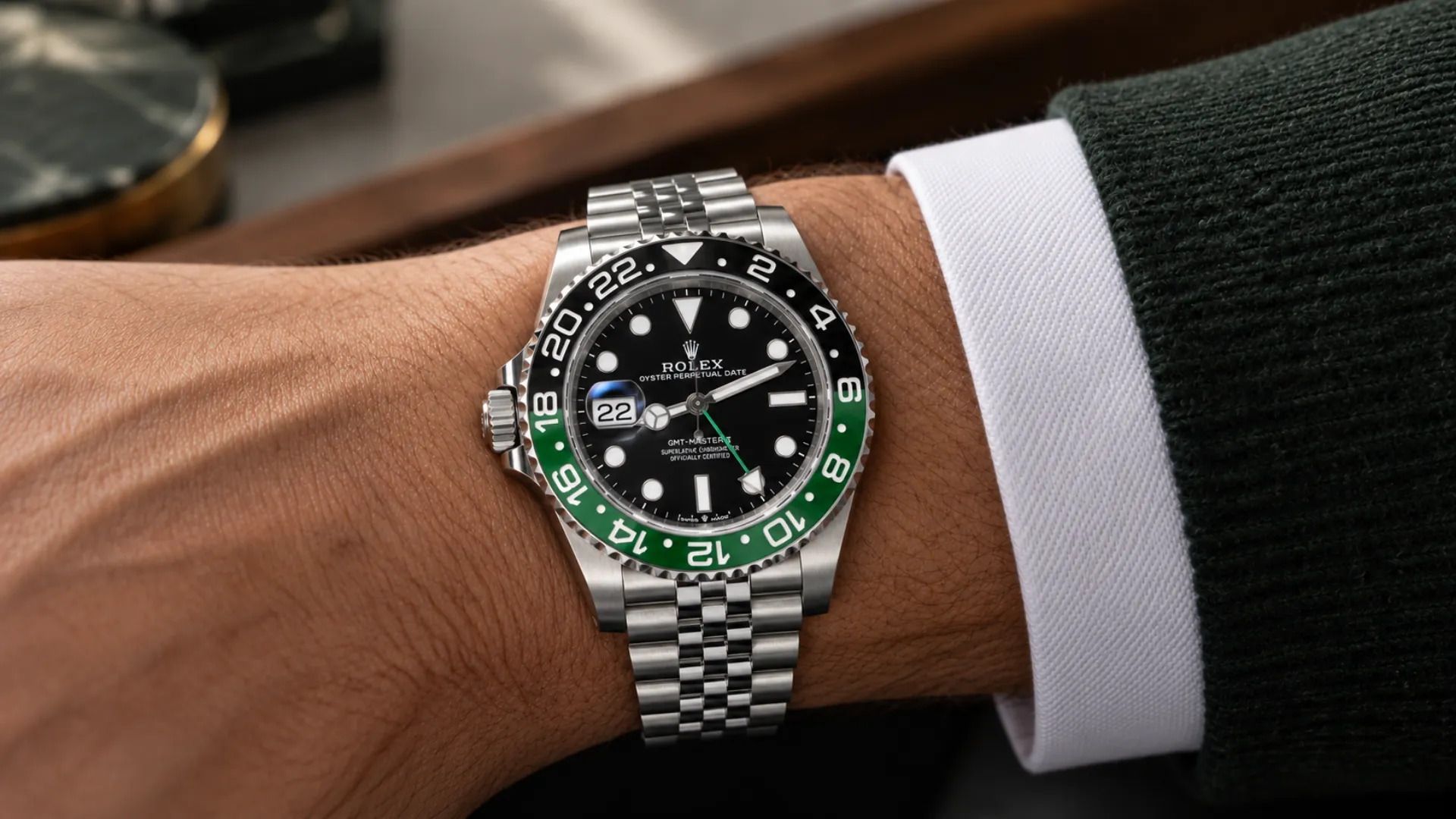 Green and black bezel Rolex GMT-Master II Sprite styled on the wrist with a charcoal sleeve
